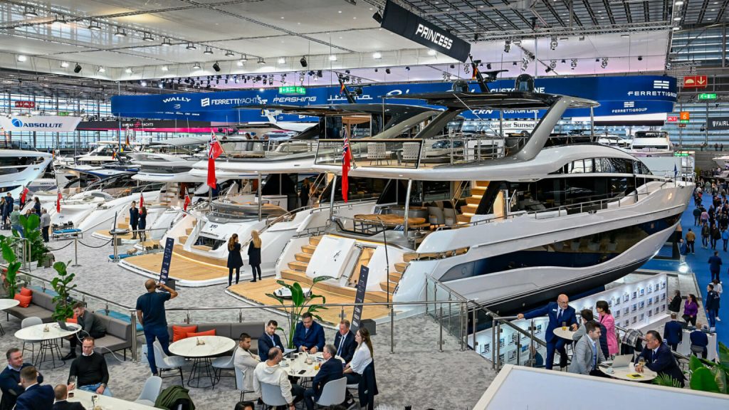 A grand display of luxury yachts at the Dusseldorf Boat Show, showcasing sleek designs and modern amenities, with visitors exploring the exhibition space.